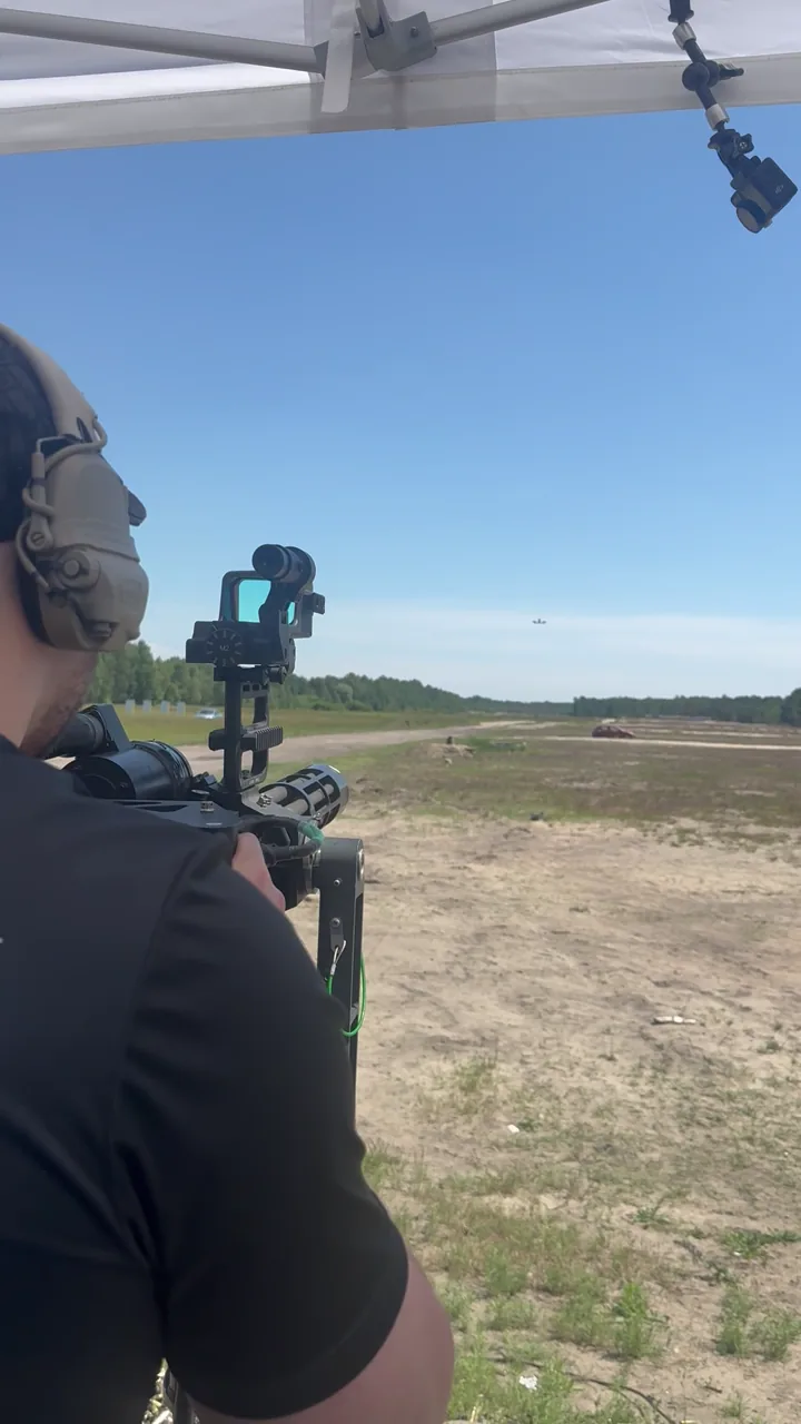 Operator conducting live-fire Gatling gun training at an outdoor range